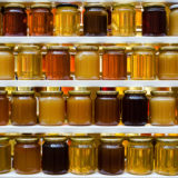 Various types of honey on a shelf